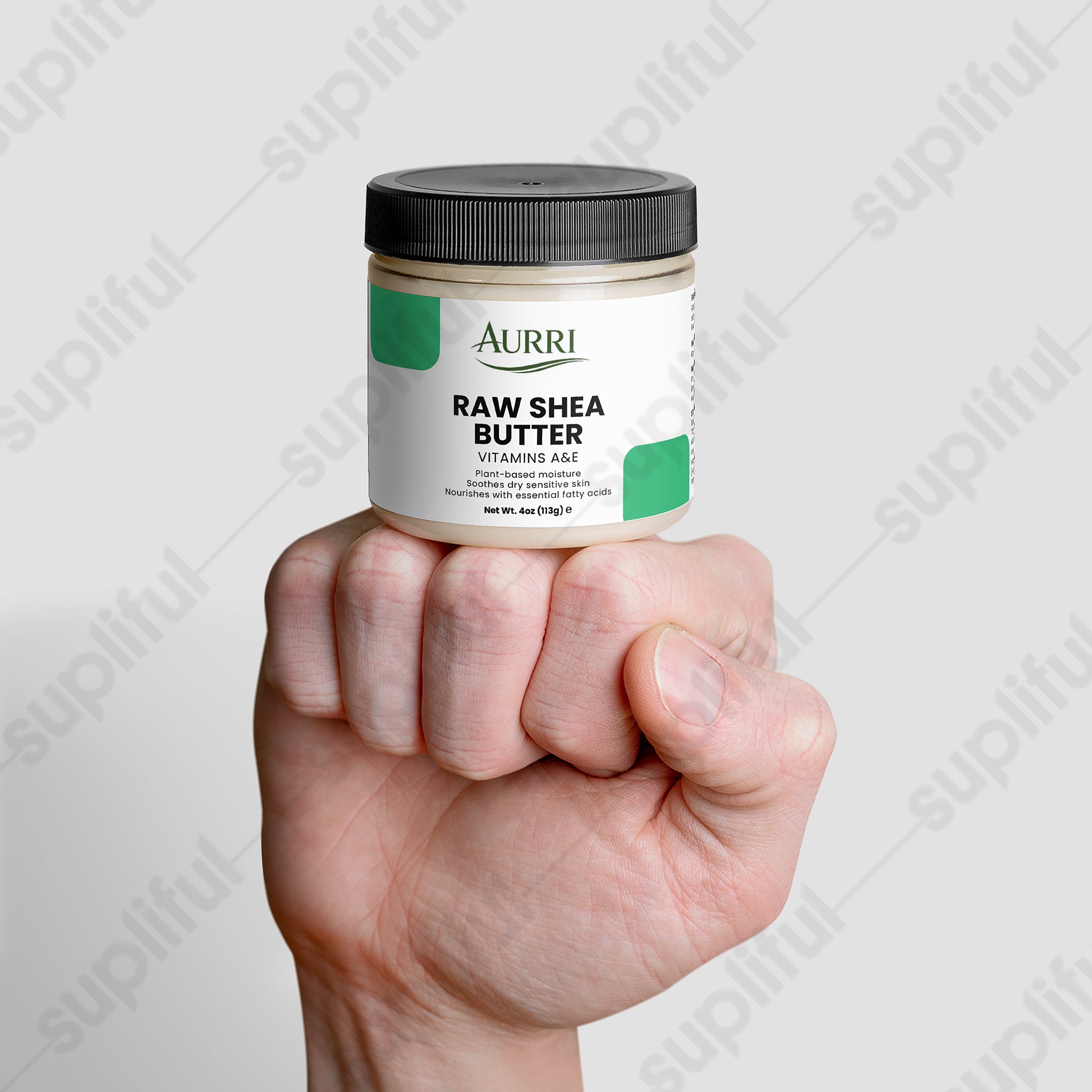 Hand holding jar of raw shea butter with vitamins A and E for dry skin