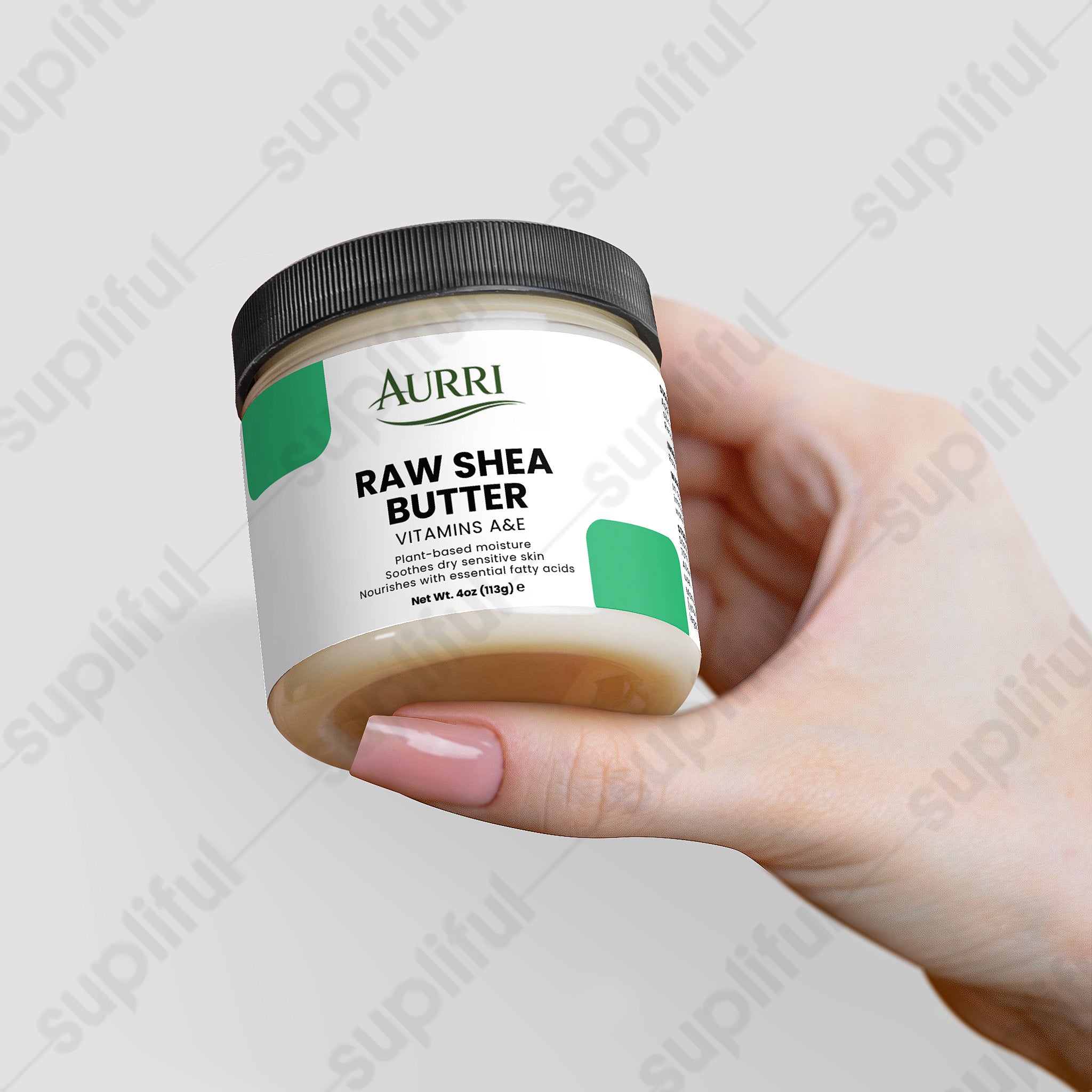 Hand holding a jar of raw shea butter skincare cream with vitamins A and E.