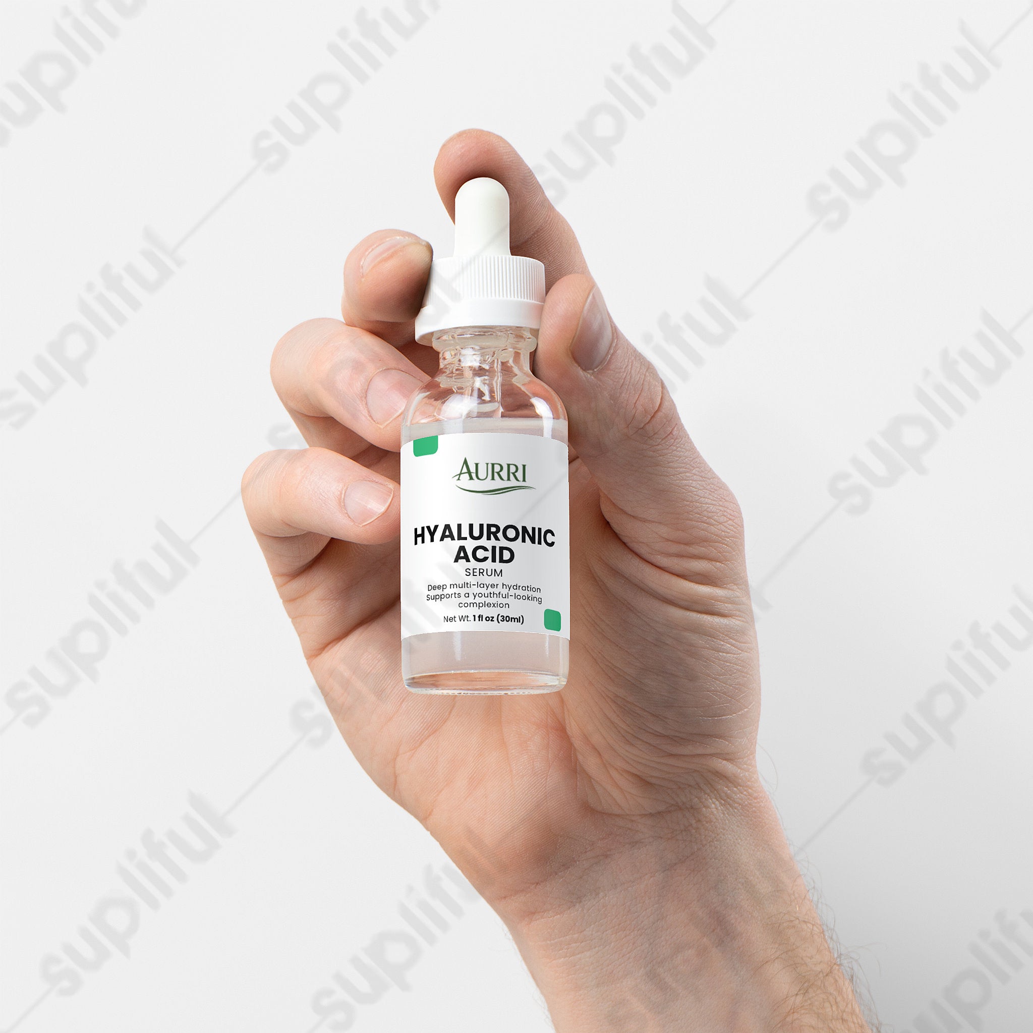 Hand holding a clear dropper bottle labeled hyaluronic acid serum for skincare